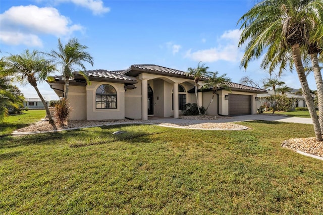 mediterranean / spanish house with a garage and a front lawn