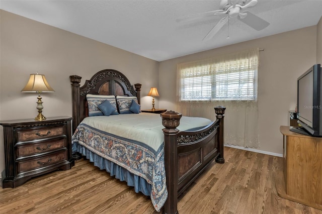 bedroom featuring wood-type flooring, a textured ceiling, and ceiling fan