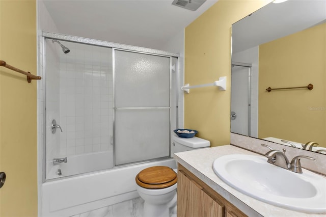 full bathroom featuring shower / bath combination with glass door, vanity, and toilet