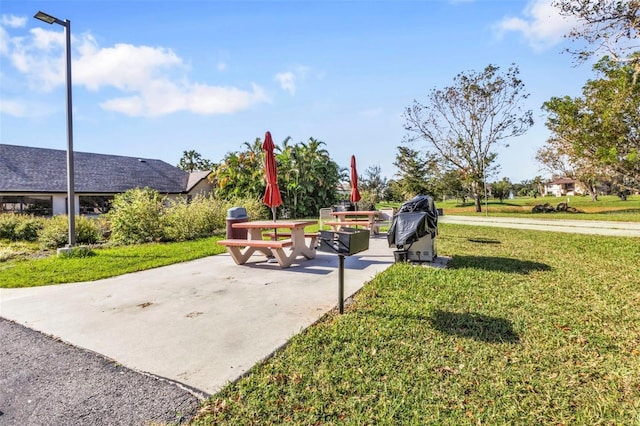 view of community with a yard and a patio