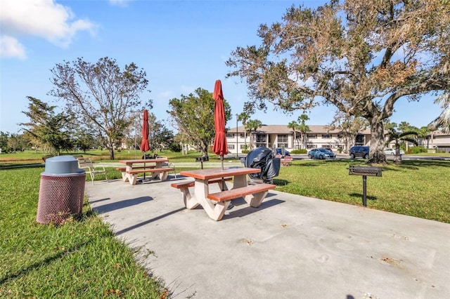 view of home's community featuring a lawn and a patio area