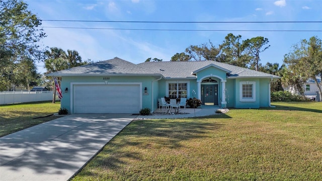 ranch-style home with a garage and a front lawn