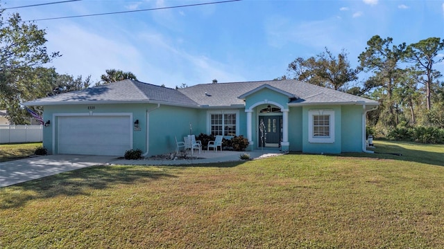 ranch-style house with a garage and a front lawn