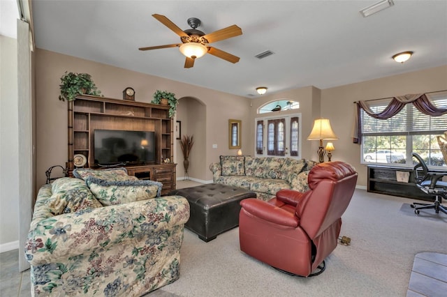 carpeted living room with ceiling fan