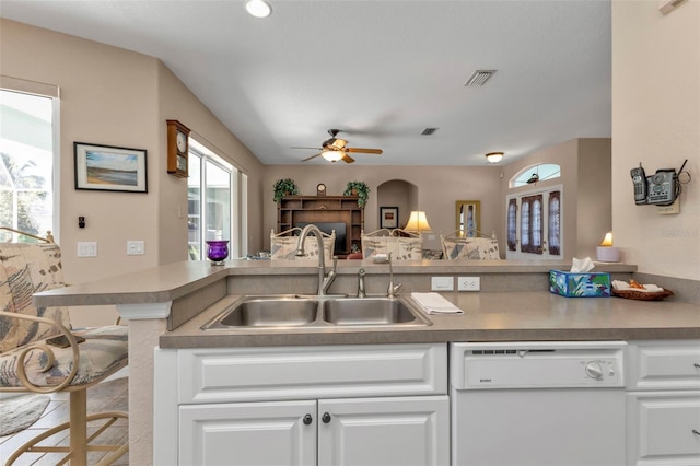 kitchen featuring kitchen peninsula, white dishwasher, white cabinetry, and sink