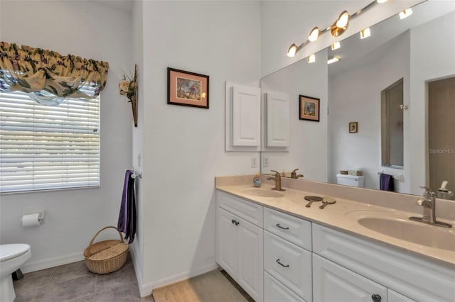 bathroom featuring tile patterned flooring, vanity, and toilet