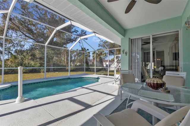 view of pool with a patio, ceiling fan, and a lanai