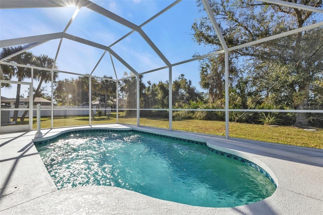 view of swimming pool with a lawn, a patio, and a lanai