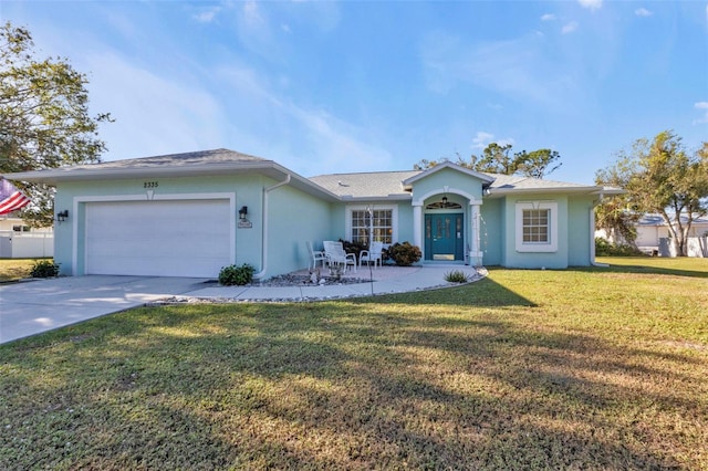 ranch-style home with a garage and a front lawn