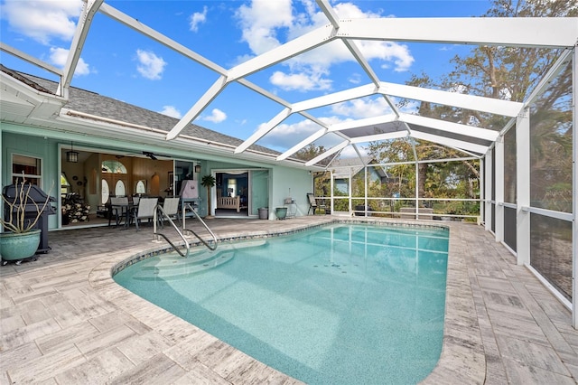 view of swimming pool with a patio area, a lanai, and ceiling fan