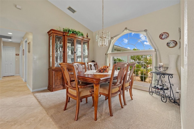 dining space with a chandelier, light tile patterned floors, and high vaulted ceiling