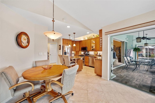 tiled dining room with vaulted ceiling