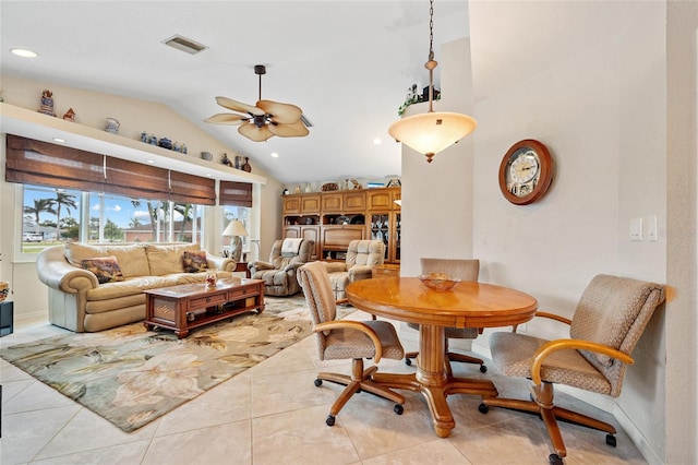 tiled dining area featuring lofted ceiling and ceiling fan