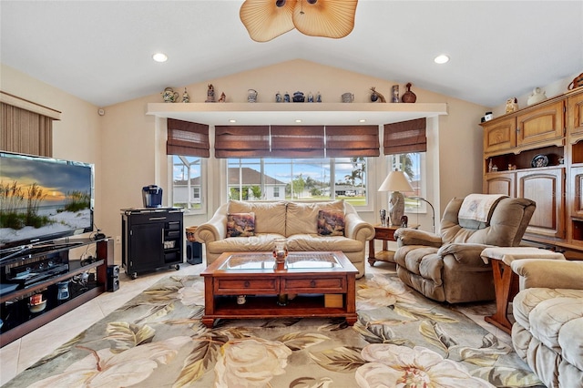 tiled living room featuring ceiling fan and vaulted ceiling