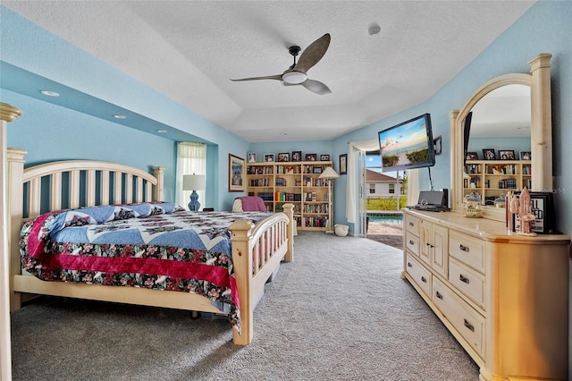 bedroom featuring ceiling fan, a textured ceiling, and light carpet