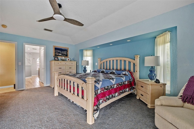 carpeted bedroom with a textured ceiling and ceiling fan