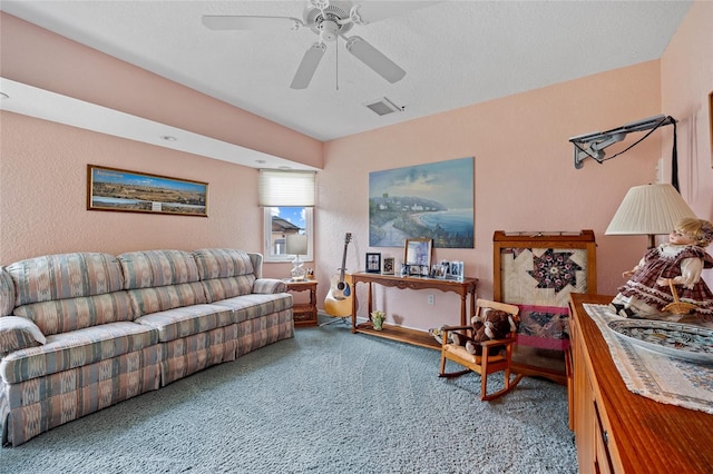 living room featuring ceiling fan, a textured ceiling, and carpet floors