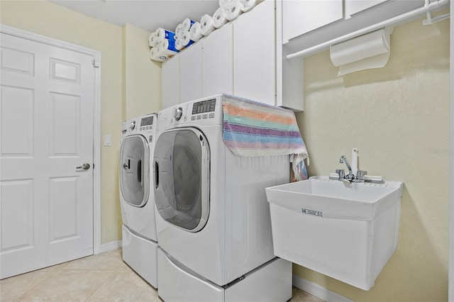 laundry room featuring light tile patterned flooring, sink, and independent washer and dryer