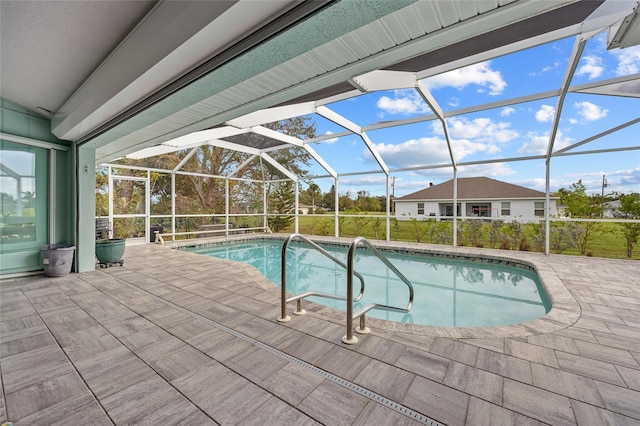 view of swimming pool with a patio and glass enclosure