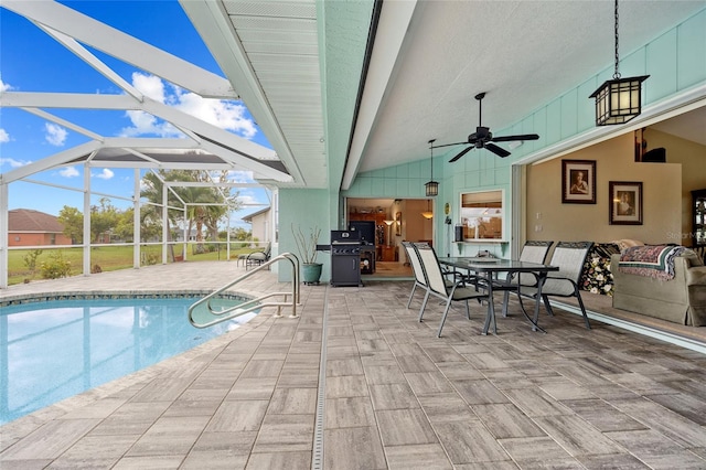 view of swimming pool featuring a lanai, area for grilling, ceiling fan, and a patio area