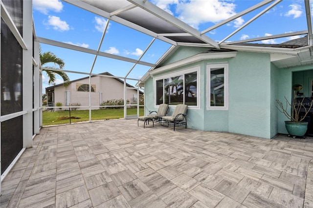 view of patio / terrace featuring glass enclosure