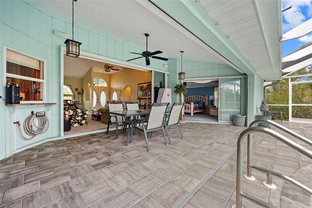 view of patio featuring a lanai and ceiling fan