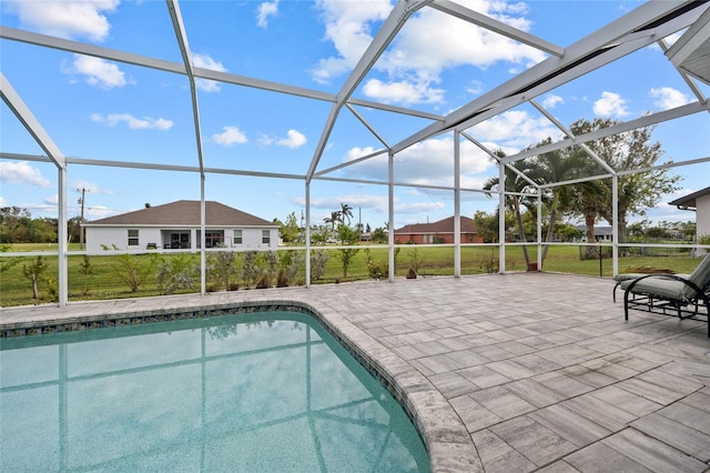 view of swimming pool with a lawn, a lanai, and a patio