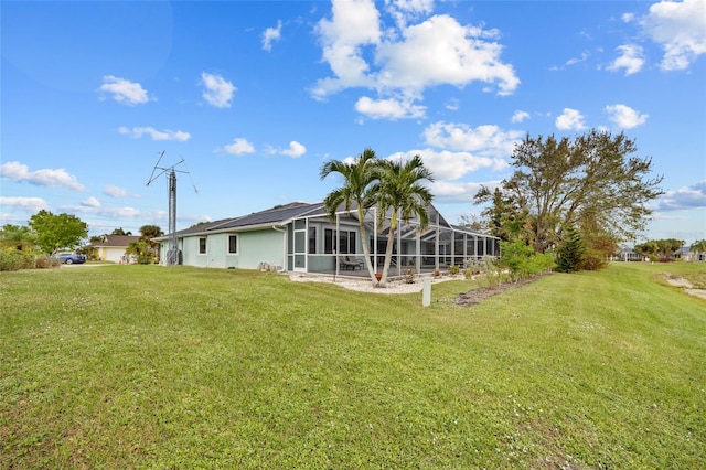 back of property with a yard and a lanai