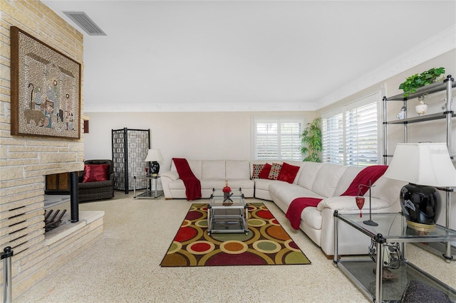 living room featuring a fireplace and crown molding