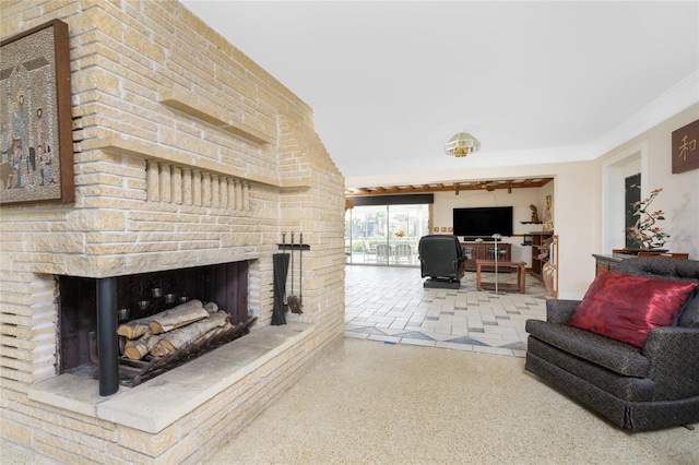 living room with ornamental molding and a fireplace