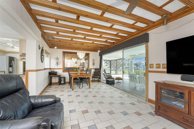 tiled living room with ceiling fan with notable chandelier