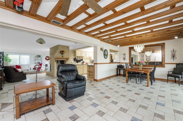 living room with an inviting chandelier and a brick fireplace