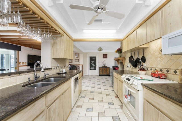 kitchen with sink, tasteful backsplash, light brown cabinets, white appliances, and pendant lighting