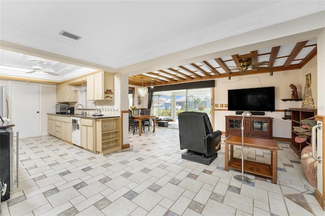 living room featuring ornamental molding and ceiling fan