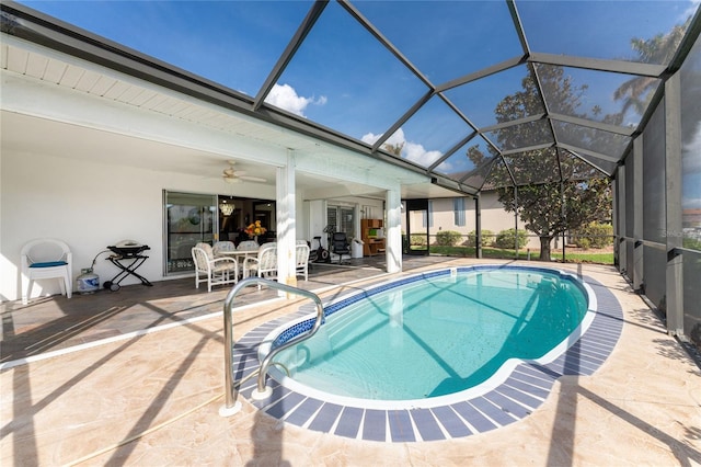 view of swimming pool with a lanai, ceiling fan, and a patio area