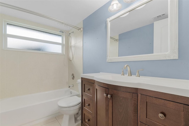 full bathroom with tiled shower / bath, vanity, toilet, and tile patterned floors