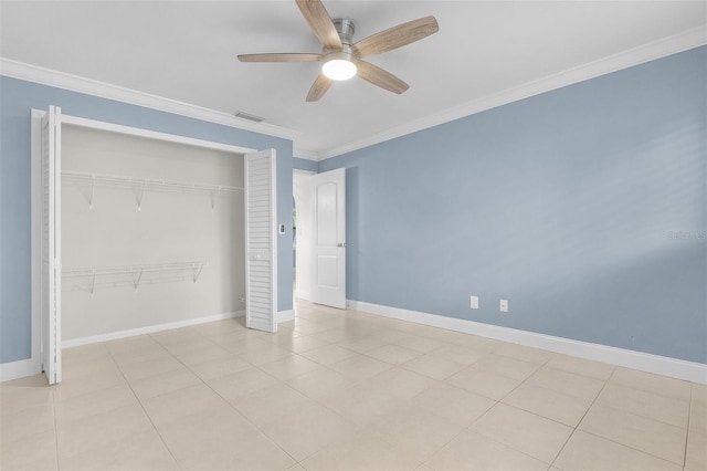 unfurnished bedroom featuring light tile patterned floors, crown molding, a closet, and ceiling fan