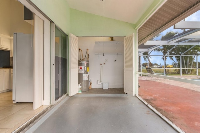 view of patio / terrace featuring electric water heater and glass enclosure