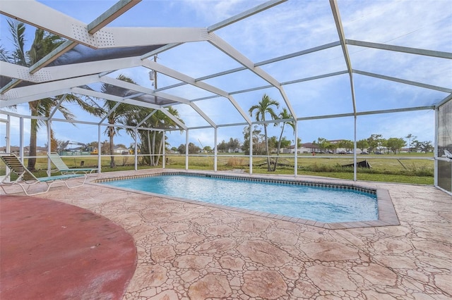 view of swimming pool featuring a patio area and a lanai