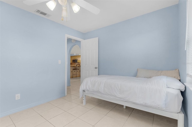 tiled bedroom with ceiling fan