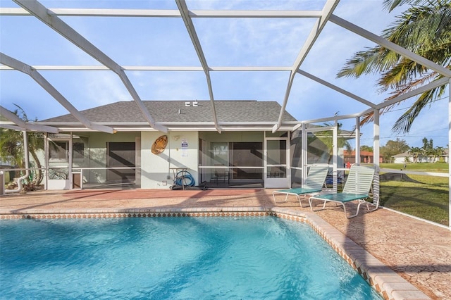 view of swimming pool with a patio and glass enclosure