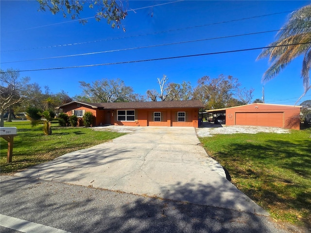 single story home featuring a front yard, a garage, and a carport