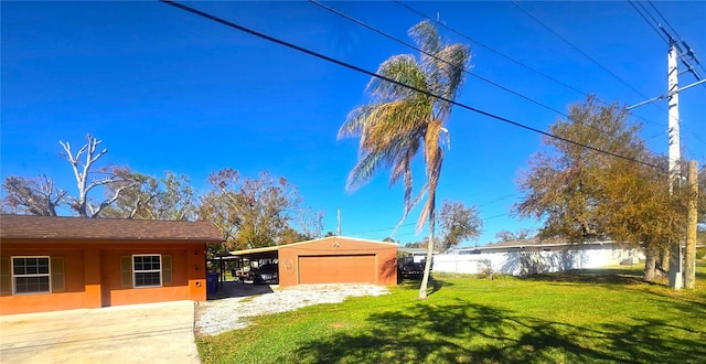 view of yard with a carport, an outdoor structure, and a garage