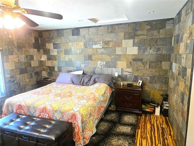 bedroom with ceiling fan and hardwood / wood-style flooring