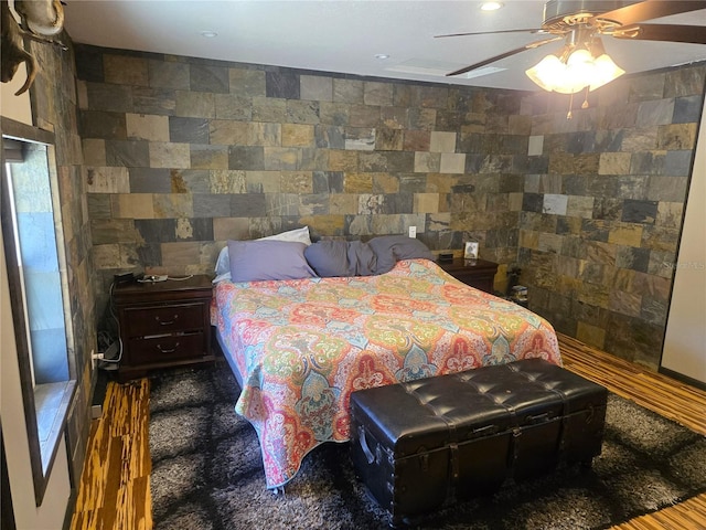 bedroom with hardwood / wood-style floors and ceiling fan