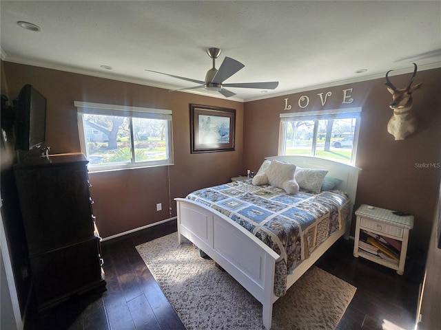 bedroom featuring dark wood-type flooring, crown molding, multiple windows, and ceiling fan