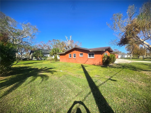 view of side of home with a lawn