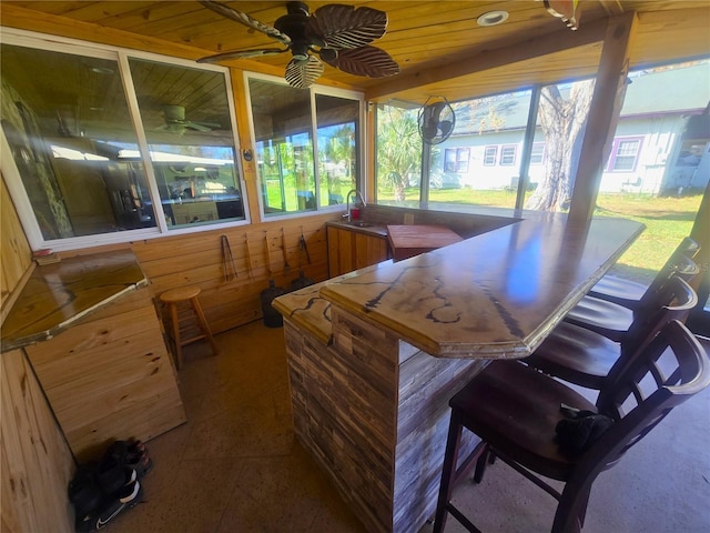 bar featuring lofted ceiling, sink, wood ceiling, and ceiling fan