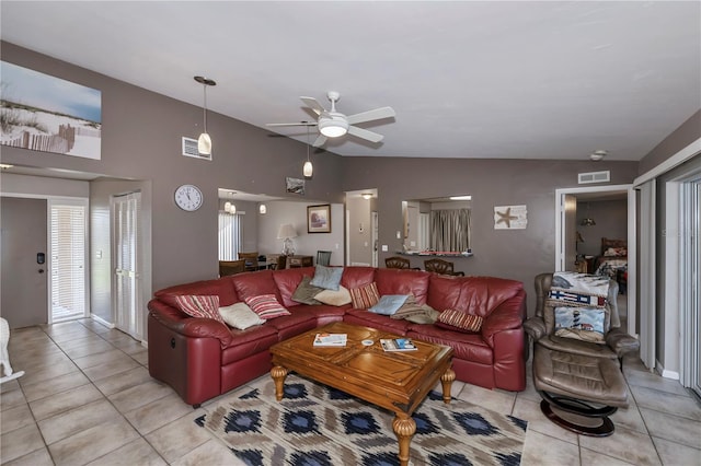 tiled living room with ceiling fan and lofted ceiling