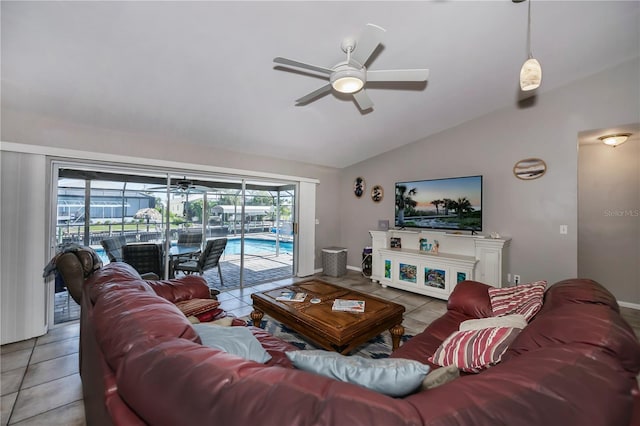 tiled living room featuring ceiling fan and lofted ceiling